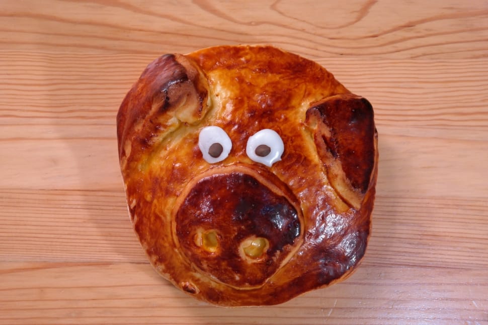 pig bread on brown wooden surface preview