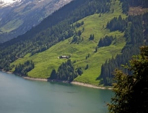 top view photography of green mountains near a body of water thumbnail