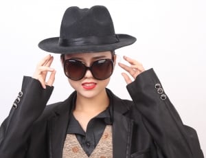 women's black hat and black long sleeve shirt and black sunglasses thumbnail