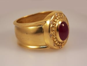 gold ring with oval red stone thumbnail