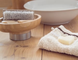 white towel, white ceramic round bowl; brown handle brush thumbnail