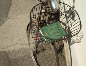 green book in black bicycle basket thumbnail