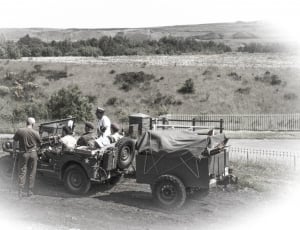 greyscale photo of armies riding on truck thumbnail