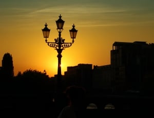silhouette of 3 light post lamp and building thumbnail