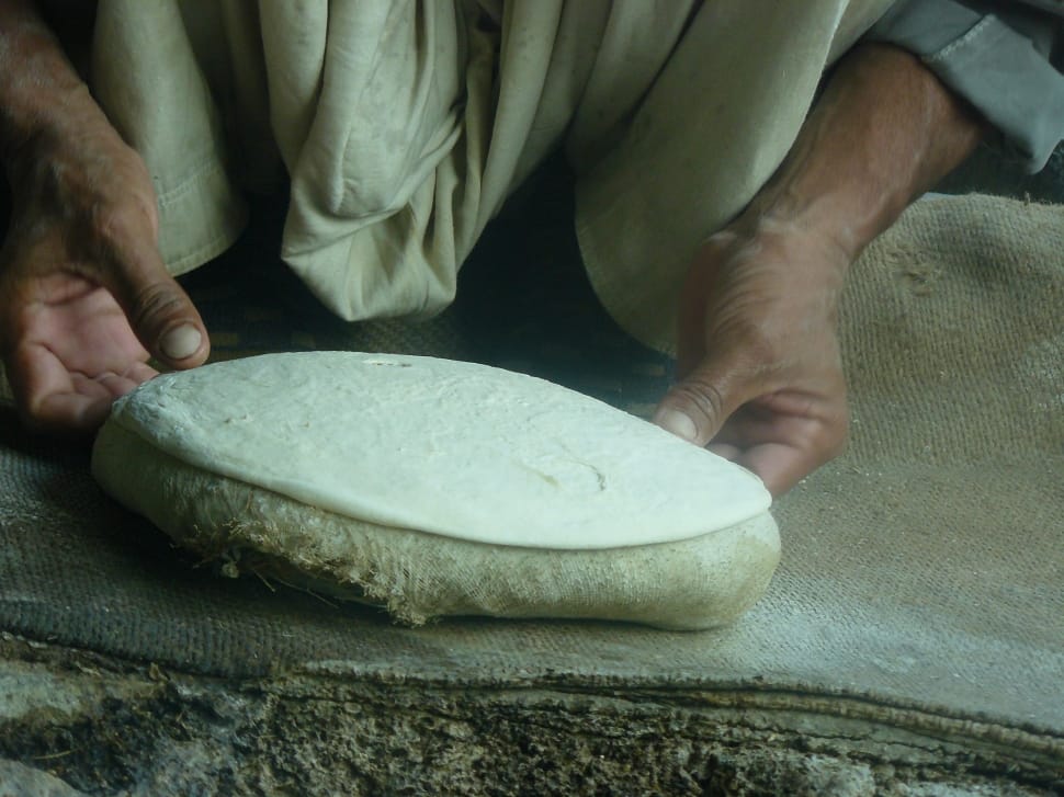 person holding white dough preview