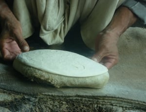 person holding white dough thumbnail