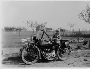 grey scale photo of child sitting on motorcycle thumbnail