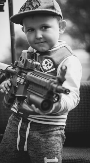 boy carrying assault rifle thumbnail