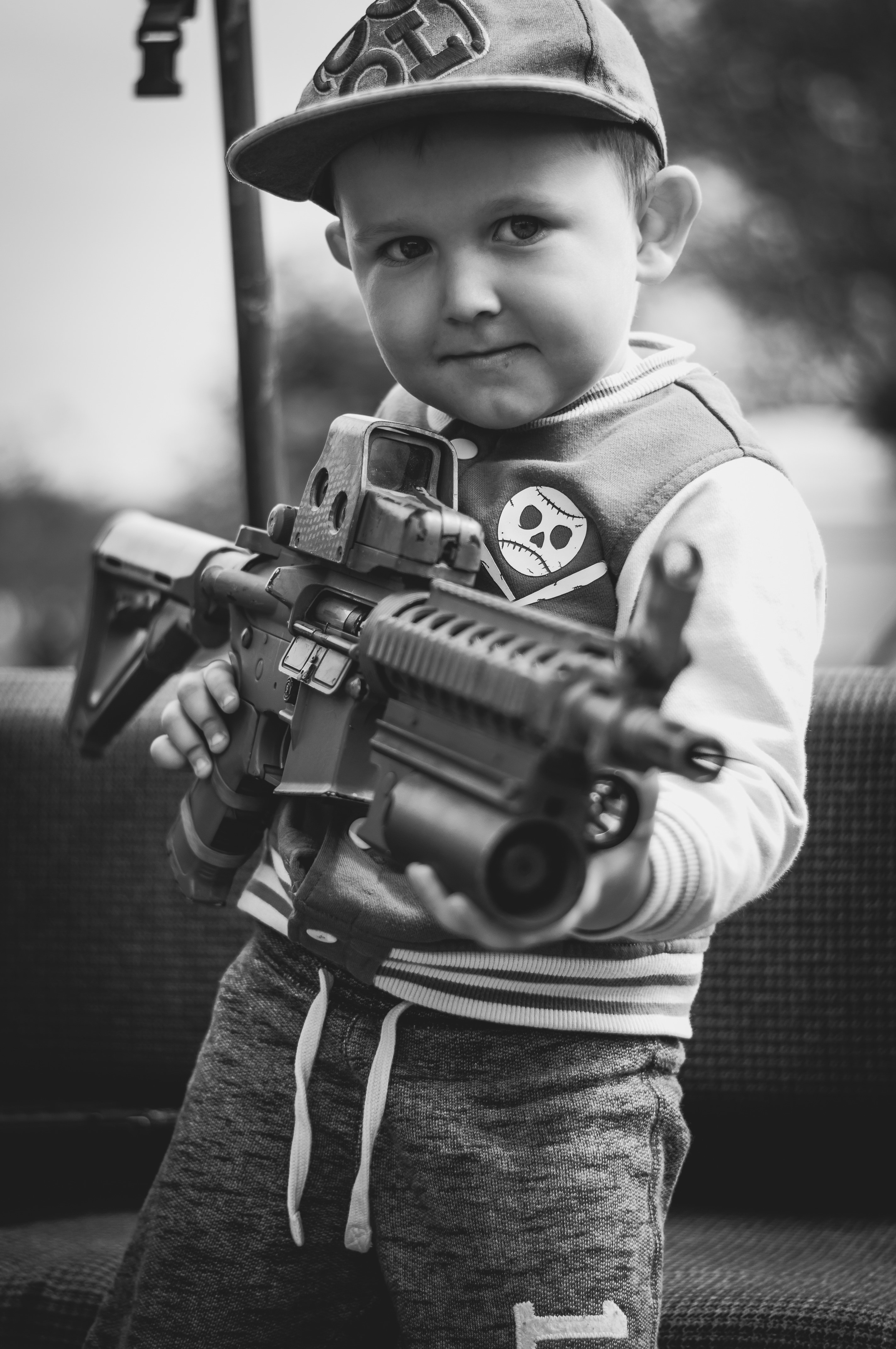 boy carrying assault rifle