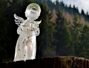 crystal angel holding candle figurine on wood stomp thumbnail