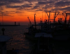 industrial ship under orange cloud during sunset thumbnail