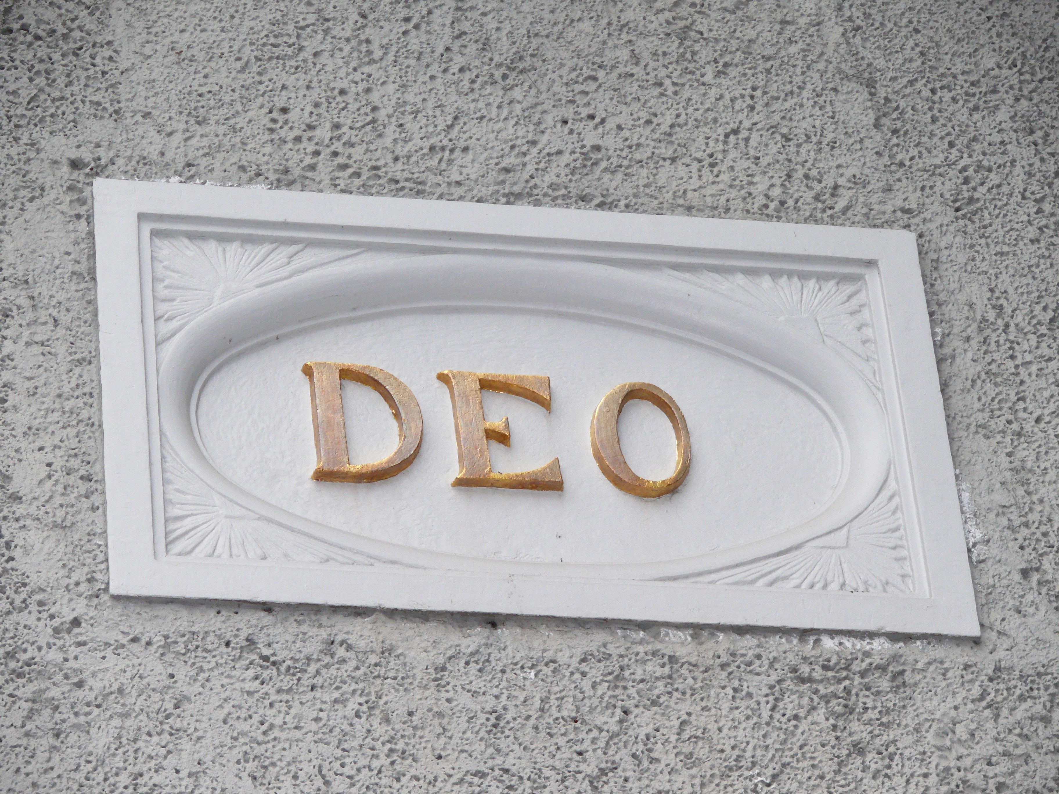 white and abrown deo wooden signage