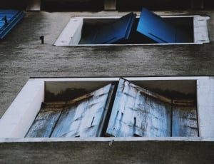 grey wooden walls with blue wooden windows thumbnail