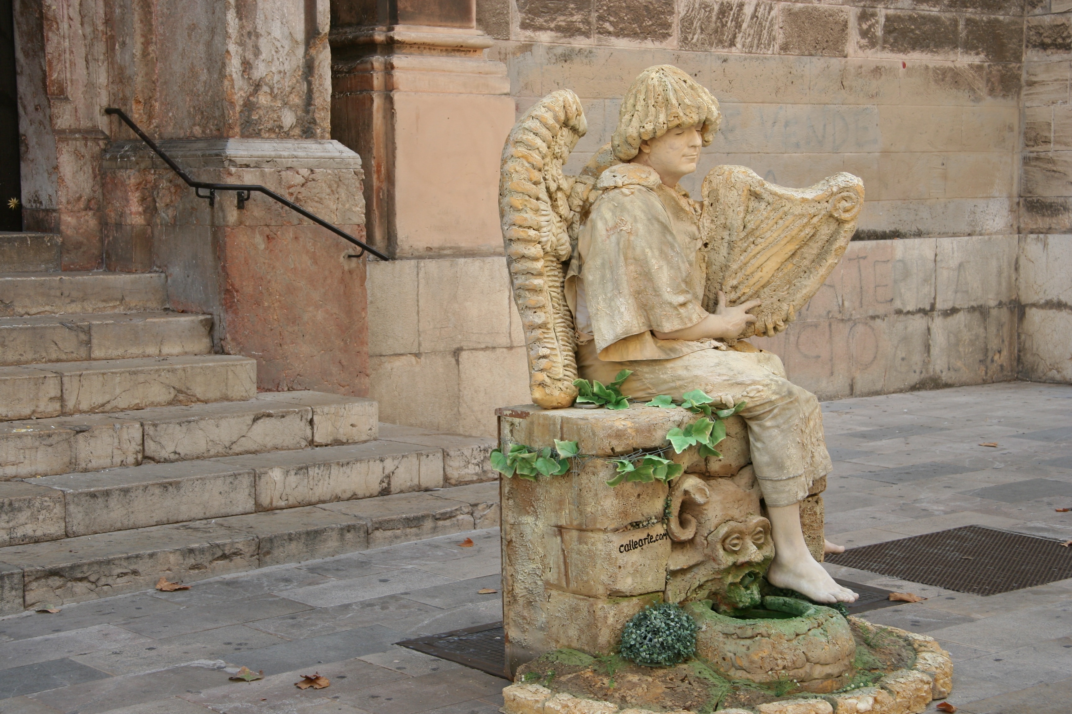 person playing harp sitting on chair figurine