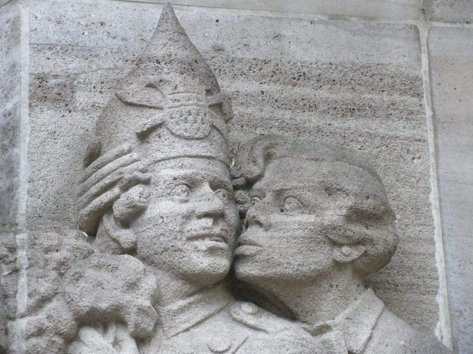 photo of woman kissing man wearing crown statue preview