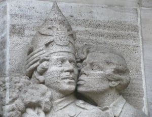photo of woman kissing man wearing crown statue thumbnail