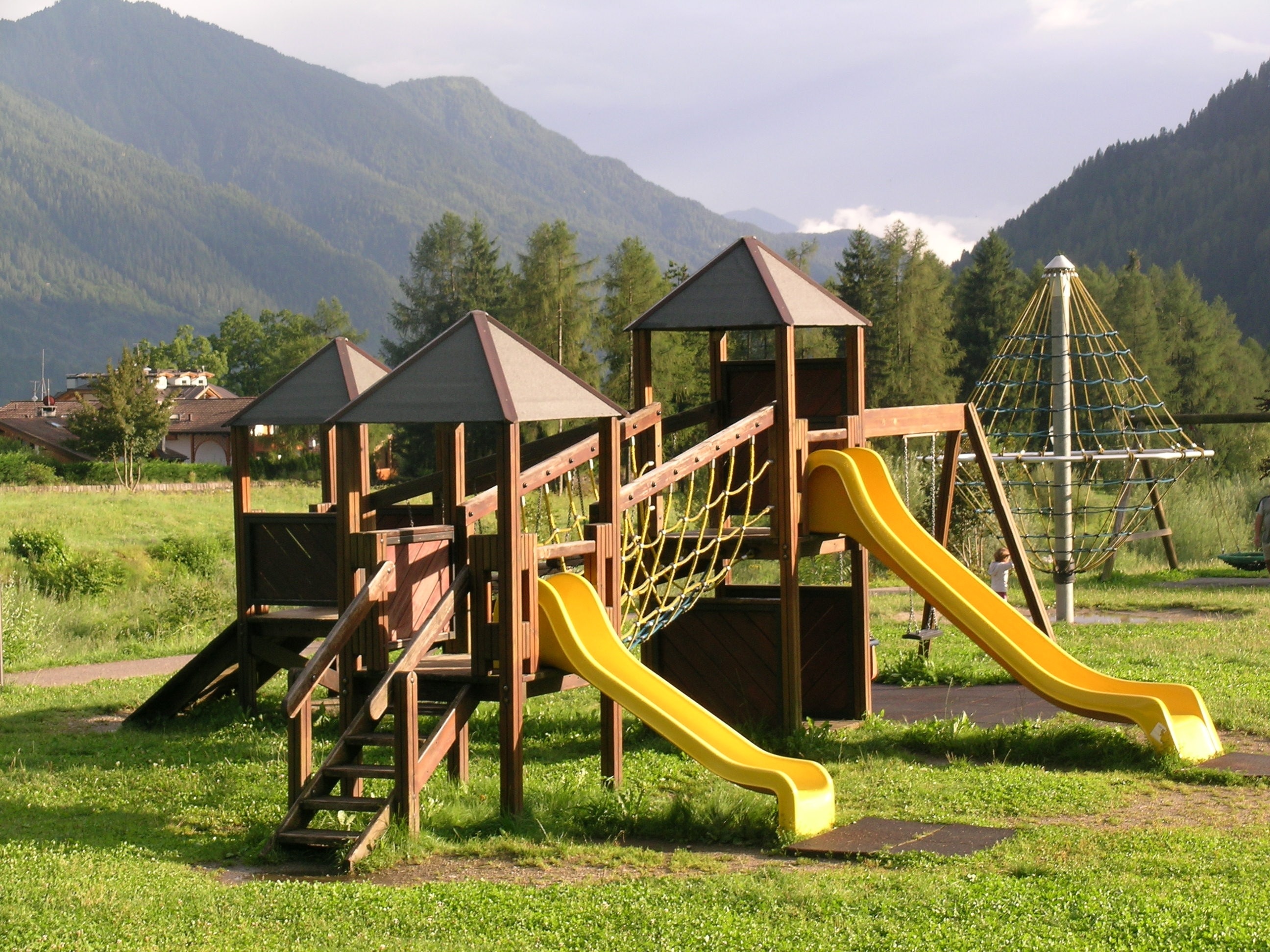 brown yellow and beige playground slide at daytime