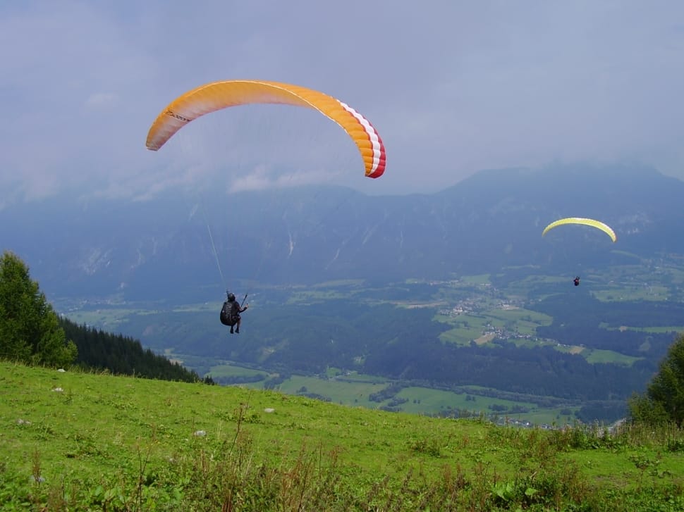 two person doing paragliding during daytime preview