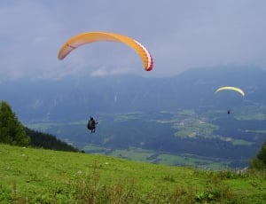 two person doing paragliding during daytime thumbnail