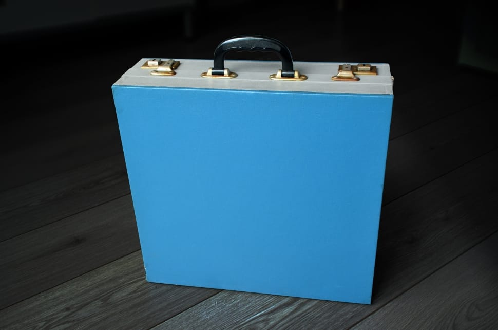 blue suitcase on parquet floor preview