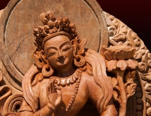 brown buddha wooden sculpture thumbnail