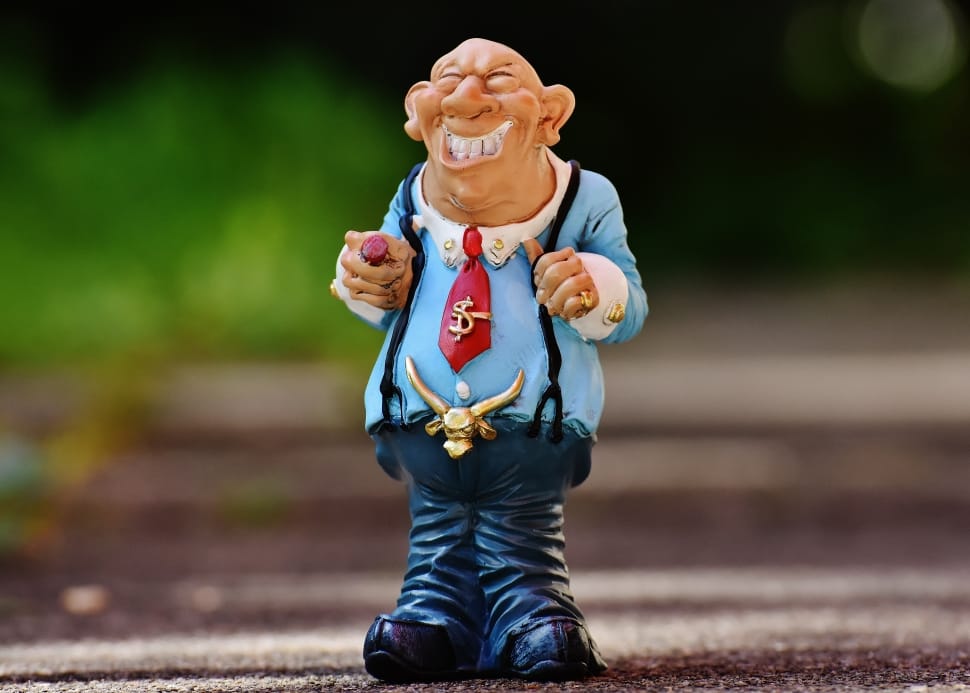 tilt shift lens photography of laughing man figurine preview