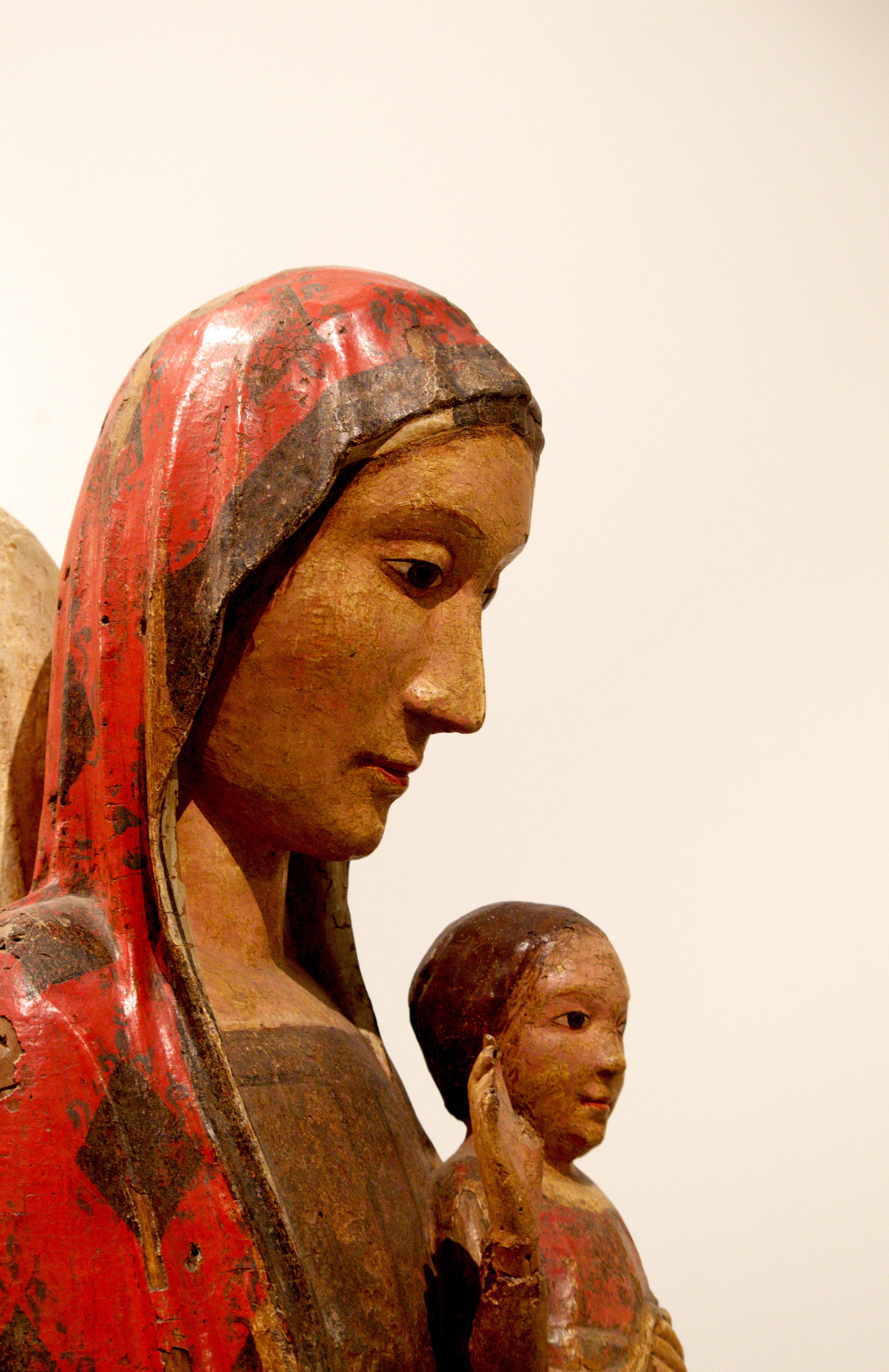 female carrying child figurine