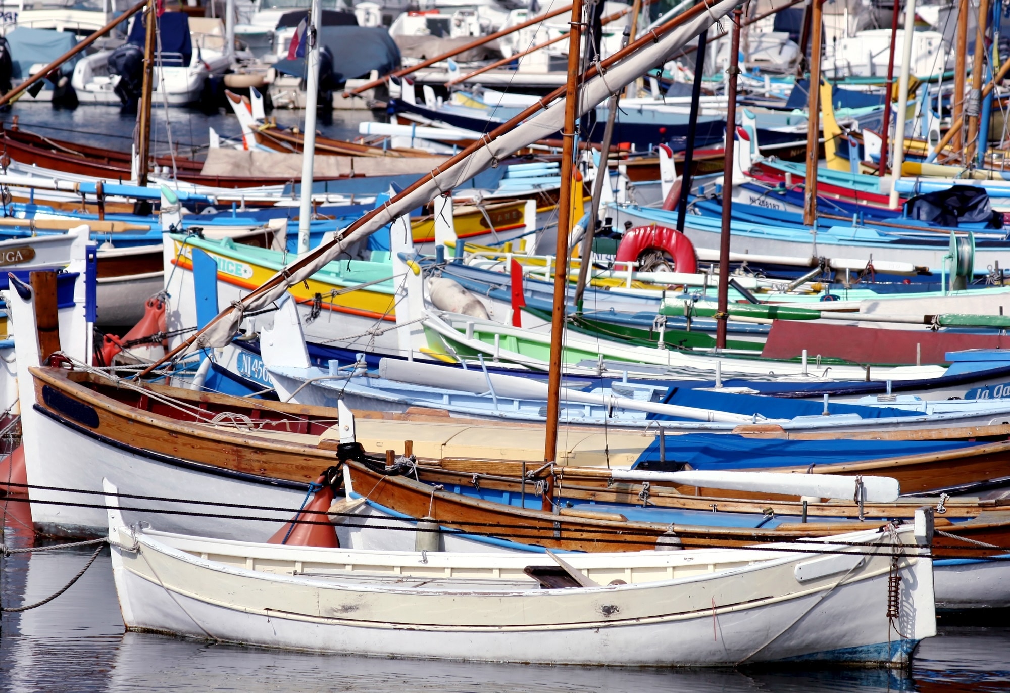 assorted color boats in sea at daytime