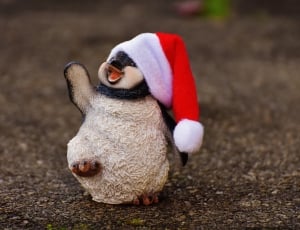 penguin wearing santa hat figurine thumbnail