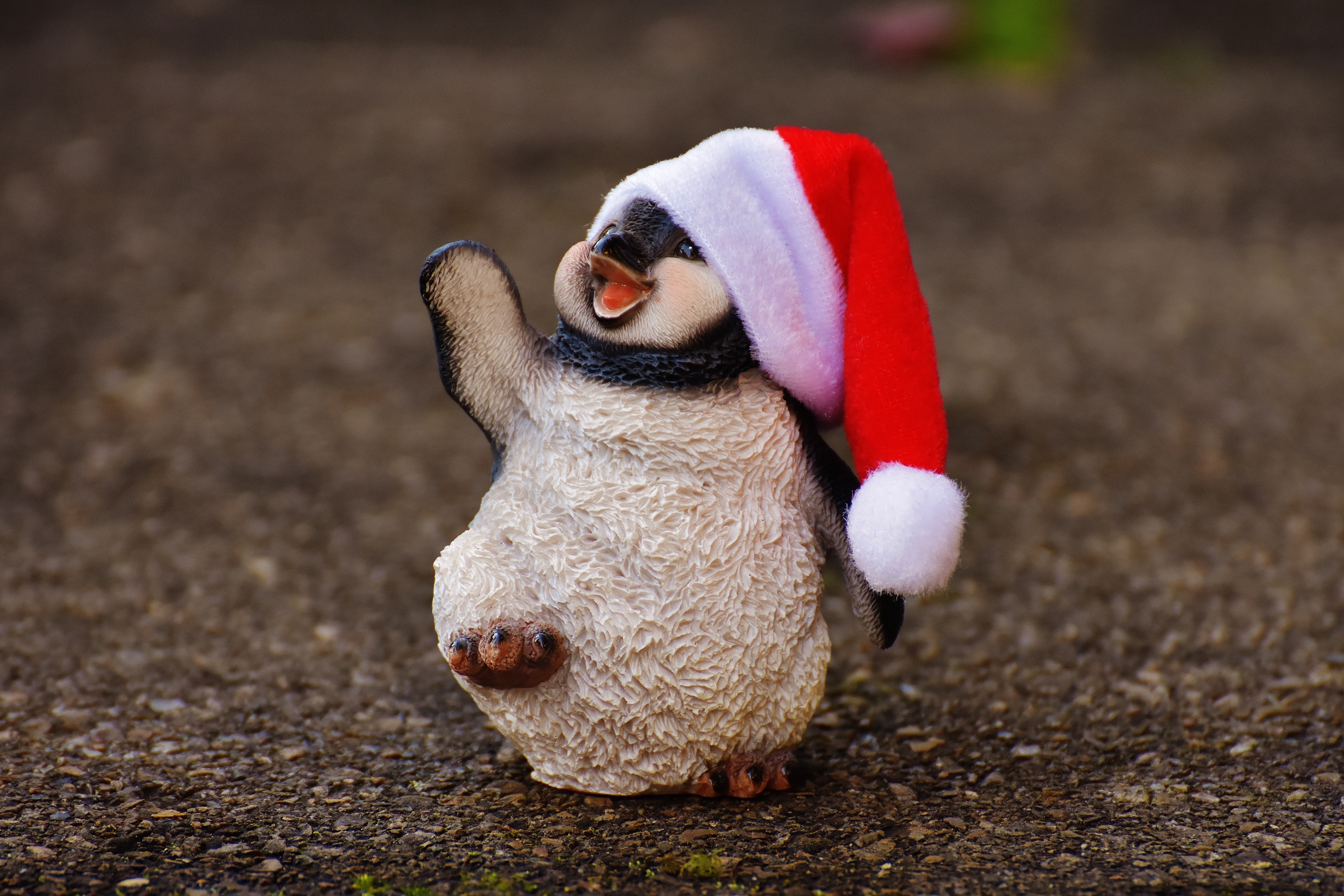 penguin wearing santa hat figurine