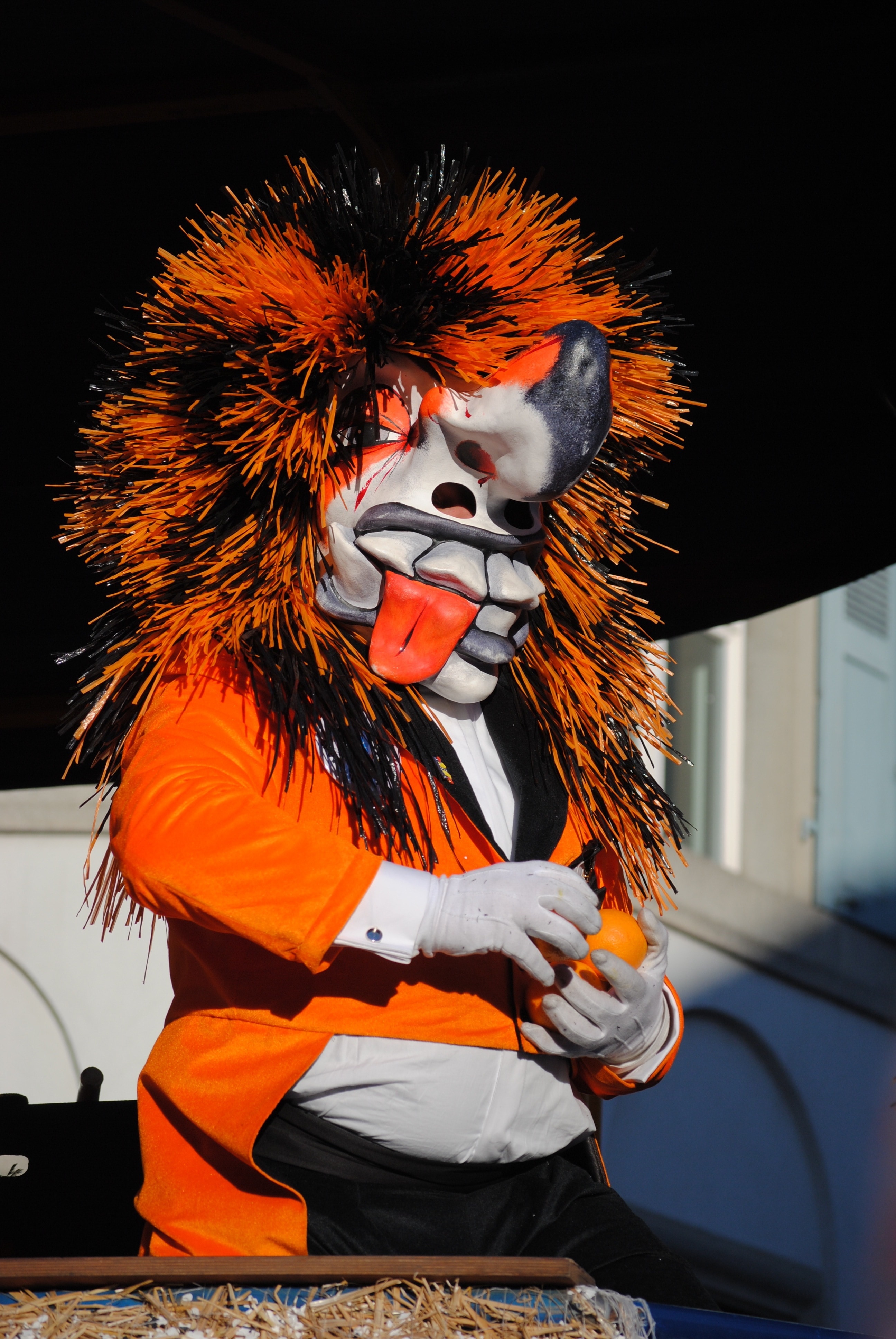 orange black and white monster character mascot