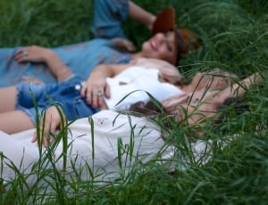 women lying on the grassfields thumbnail