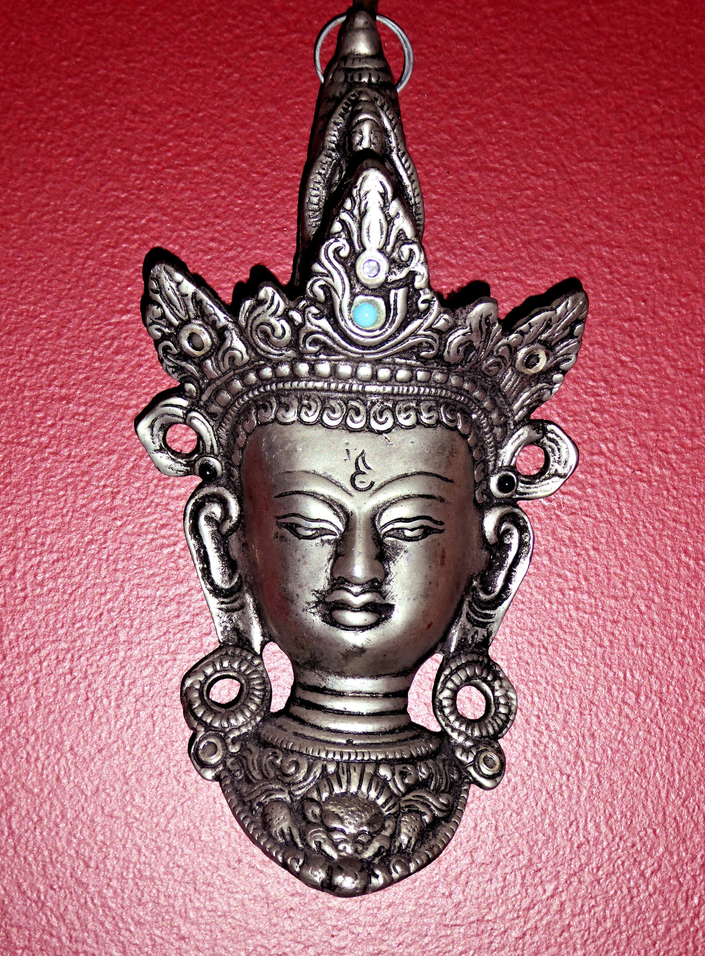 silver hindu deity emblem