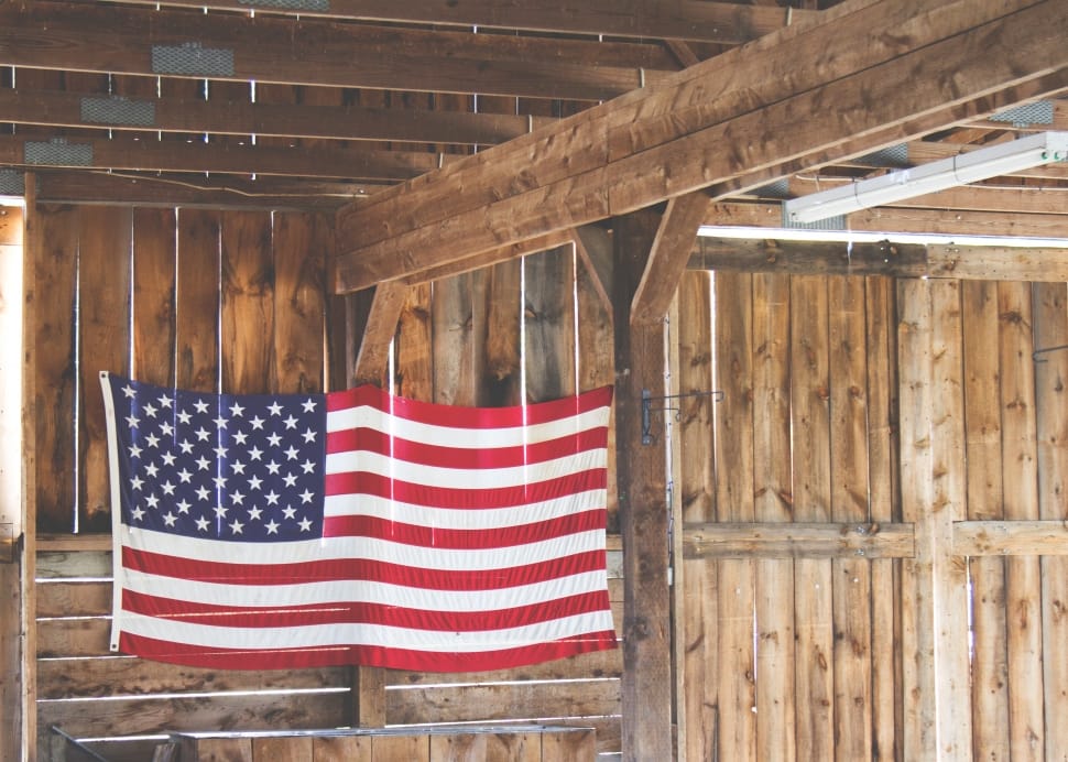 flag of u.s.a. hanged on beige wood slatted house preview