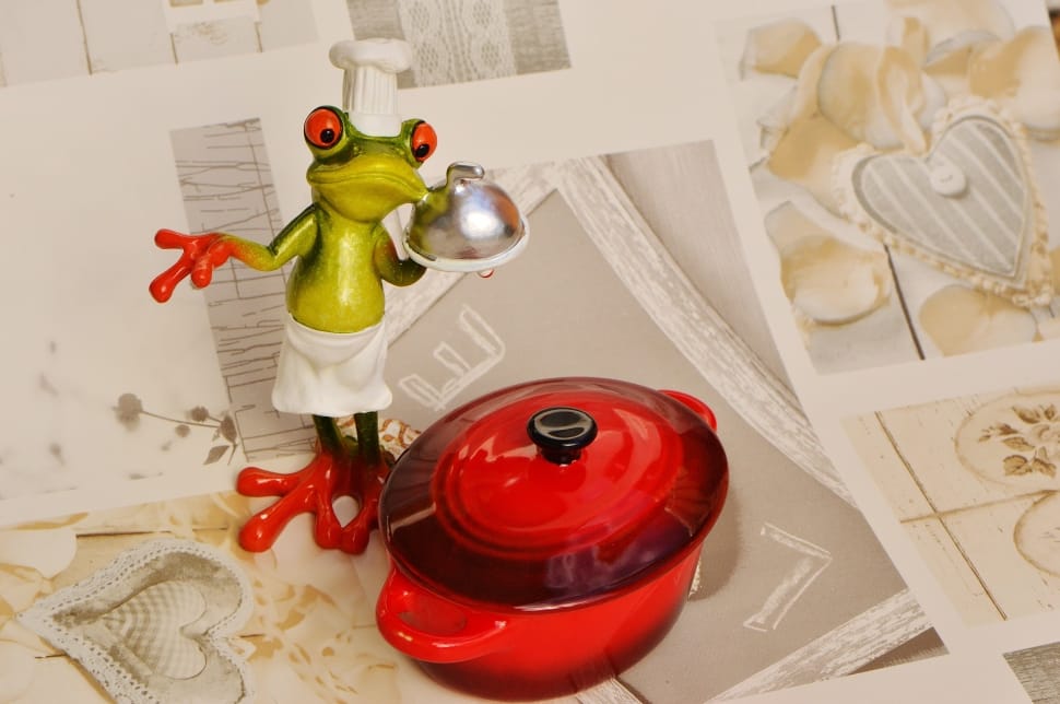 green chef frog figurine beside red casserole preview