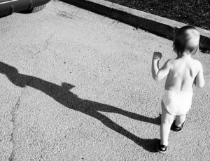 gray scale photo of baby walking thumbnail