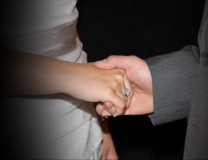 man holding woman hand in formal dress during nightime thumbnail