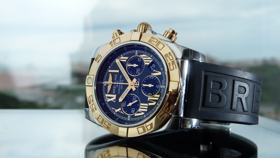black rubber strapped gold round framed blue face chronograph watch preview