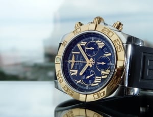 black rubber strapped gold round framed blue face chronograph watch thumbnail
