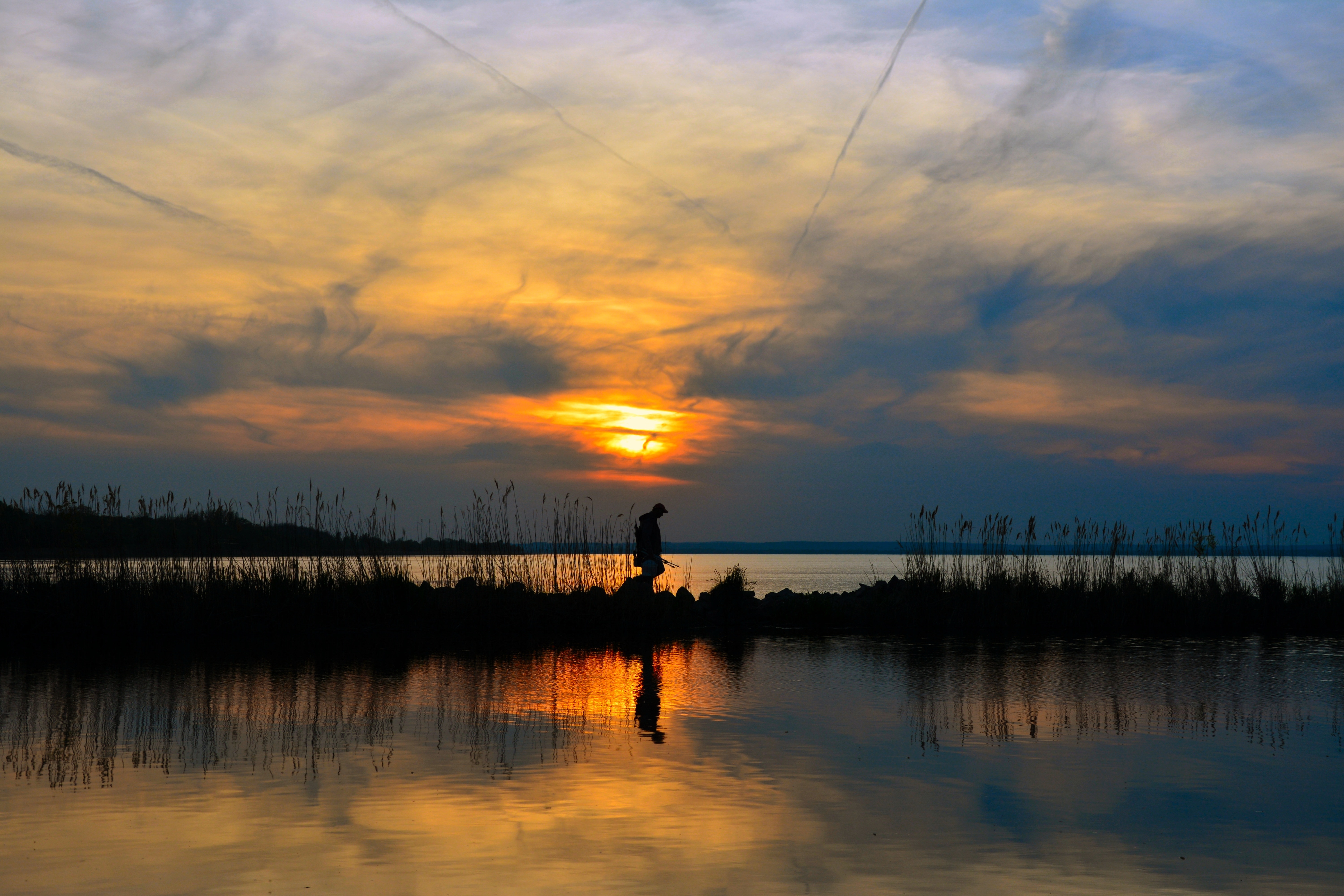 silhouette photo of man near river