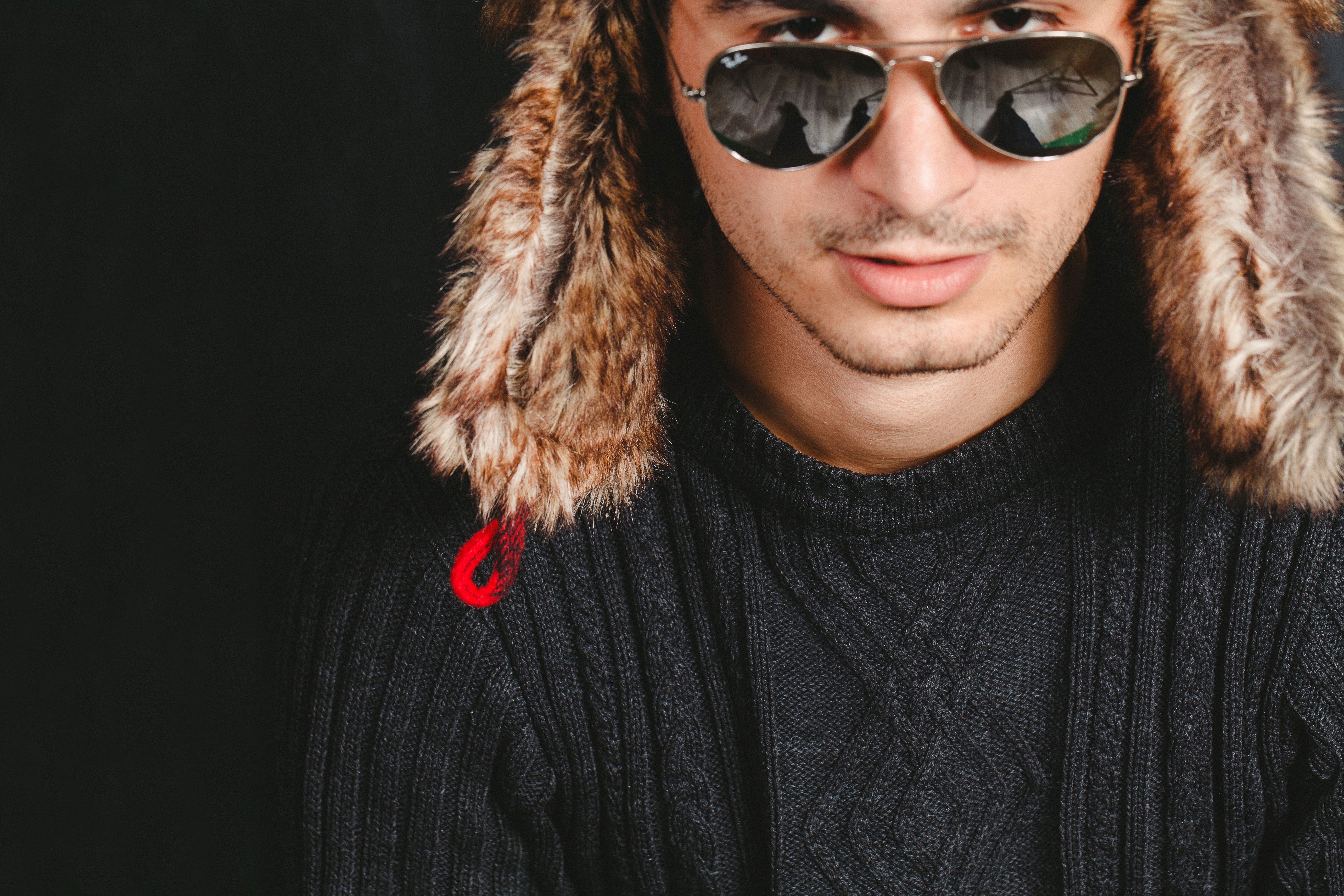 man in black sweater wearing ray ban gold frame aviator sunglasses portrait photography
