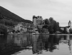 grayscale photography of house near body of water thumbnail
