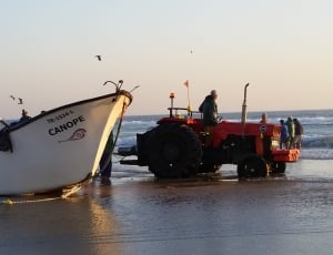 red tractor and white canope boat thumbnail