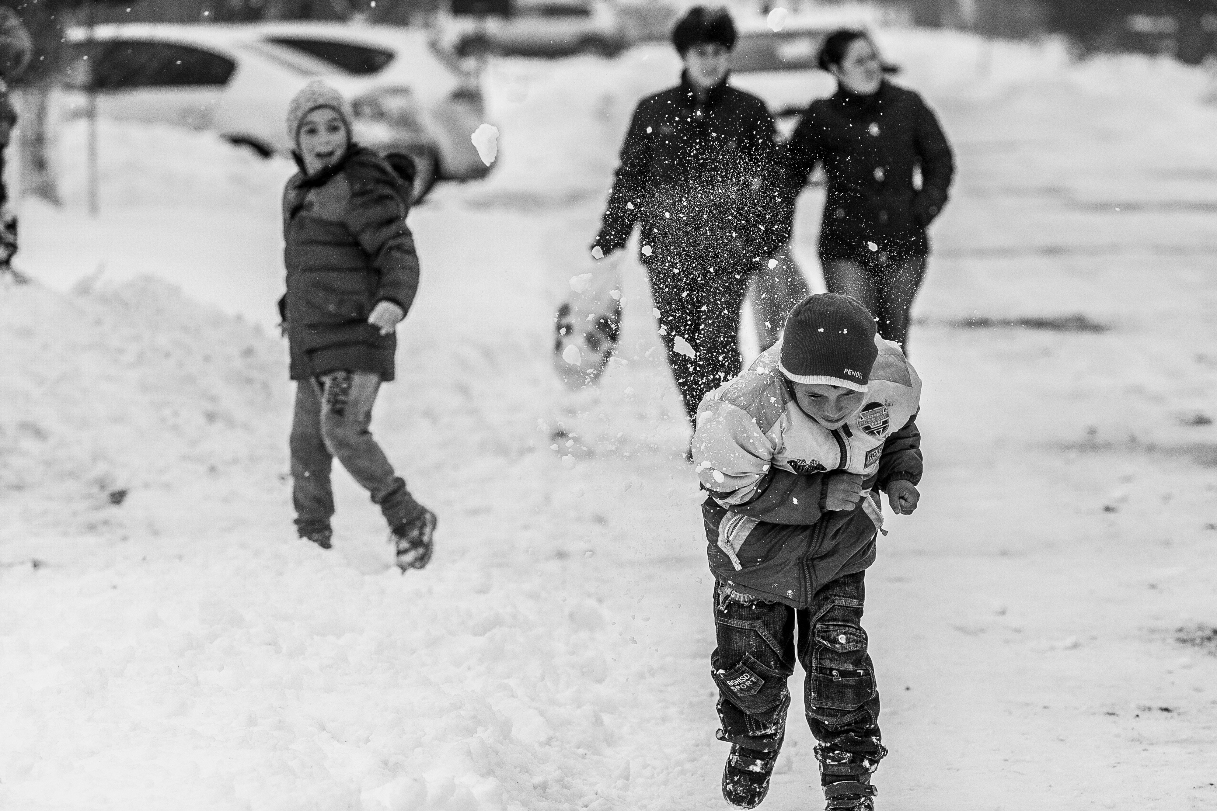people playing in the snow during day time