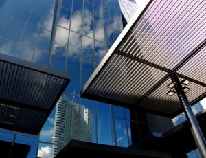 two gray steel roof panels beside glass building thumbnail