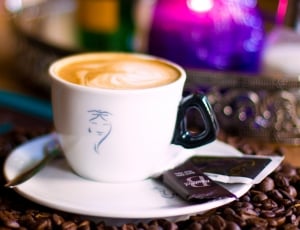 tilt shift photo of coffee filled white ceramic teacup on white saucer thumbnail