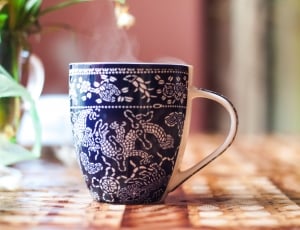 white and black ceramic coffee mug thumbnail