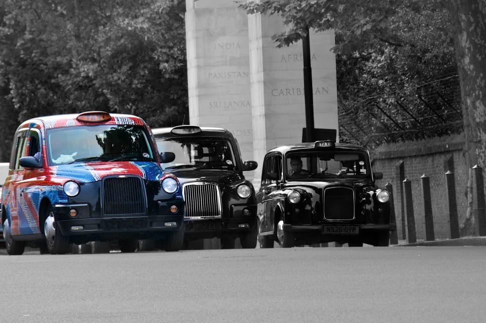 blue and red sedan in grayscale photography preview