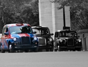 blue and red sedan in grayscale photography thumbnail