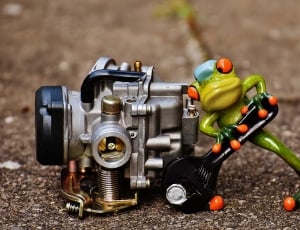 grey and black metal square equipment and green orange ceramic frog thumbnail